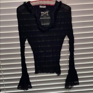 Black sheet ruffled top with intricate collar and buckle